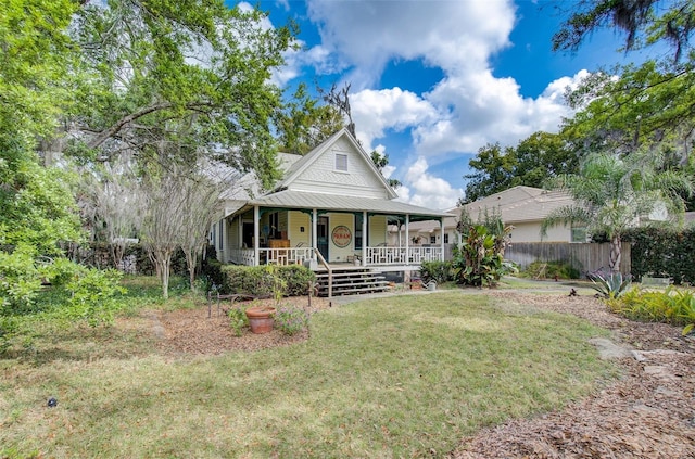 view of front of house with a front yard and covered porch