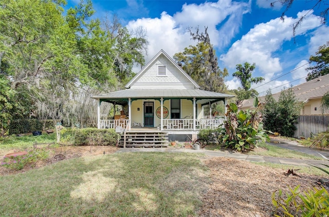 country-style home with covered porch and a front yard