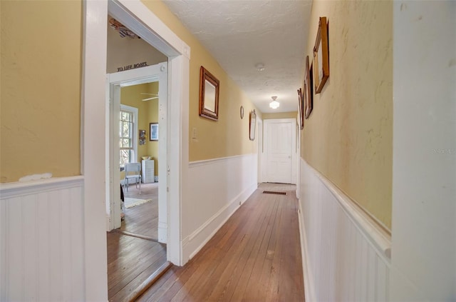 hallway with hardwood / wood-style flooring