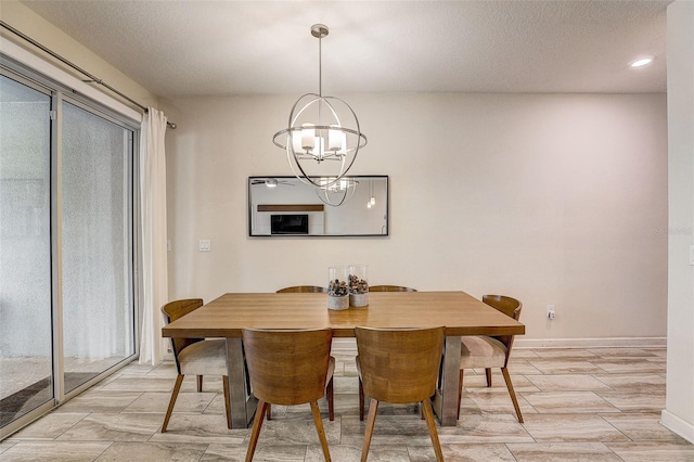 dining space featuring a textured ceiling and a notable chandelier