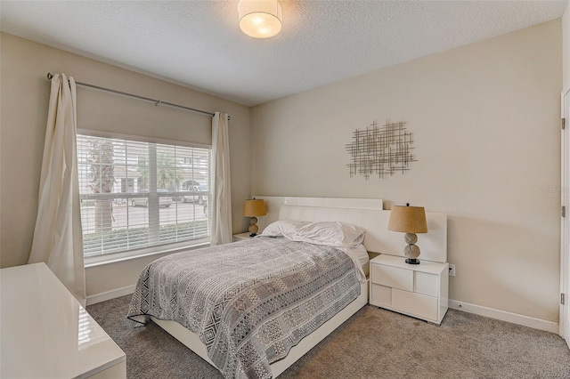 carpeted bedroom with a textured ceiling