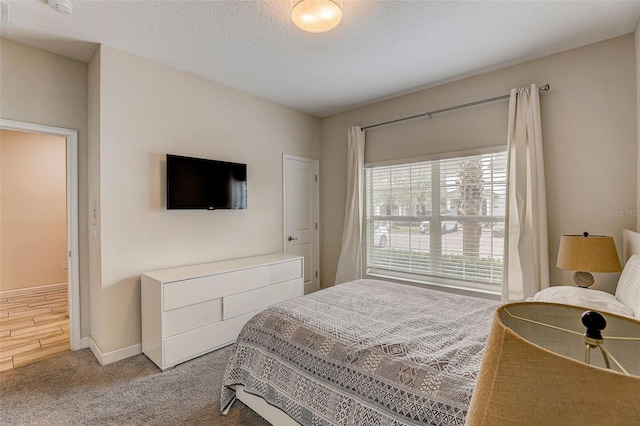 carpeted bedroom with a textured ceiling