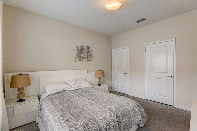 carpeted bedroom with a textured ceiling