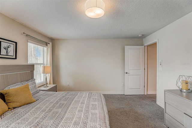 bedroom featuring carpet and a textured ceiling