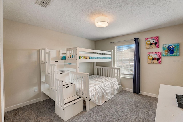 bedroom featuring dark colored carpet and a textured ceiling