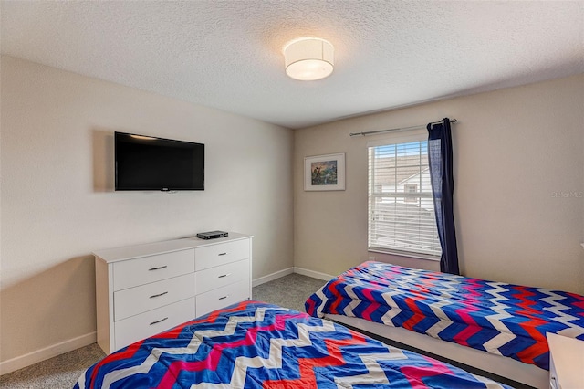 carpeted bedroom featuring a textured ceiling