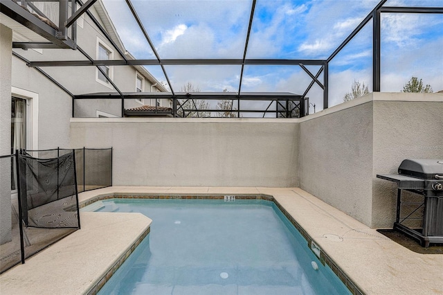 view of pool featuring area for grilling and a lanai