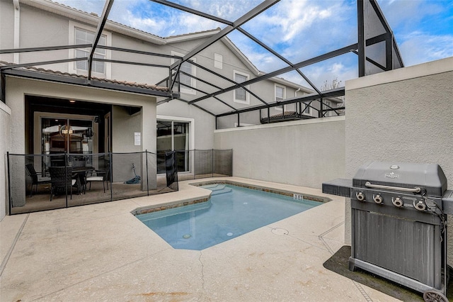 view of swimming pool featuring area for grilling, a lanai, and a patio area