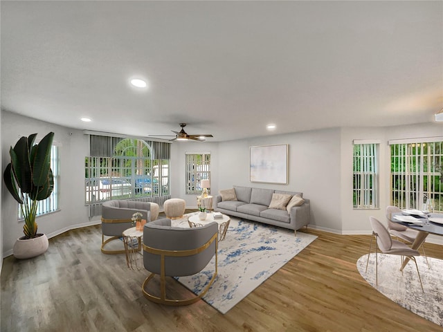 living room featuring plenty of natural light, light hardwood / wood-style floors, and ceiling fan