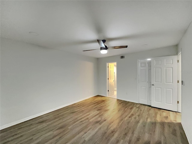 spare room featuring ceiling fan and dark hardwood / wood-style flooring