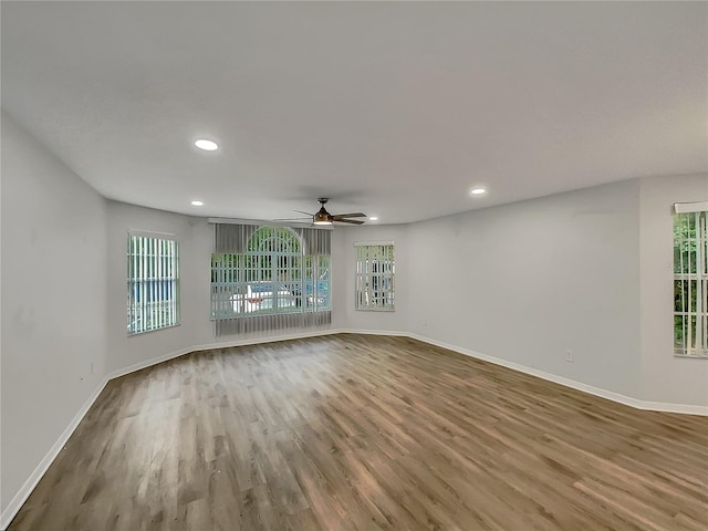 unfurnished room with dark hardwood / wood-style floors and ceiling fan