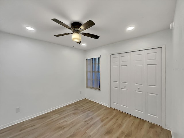 unfurnished bedroom featuring a closet, ceiling fan, and light hardwood / wood-style flooring