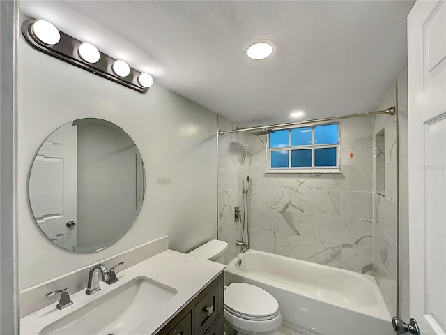 full bathroom featuring vanity, toilet, and tiled shower / bath