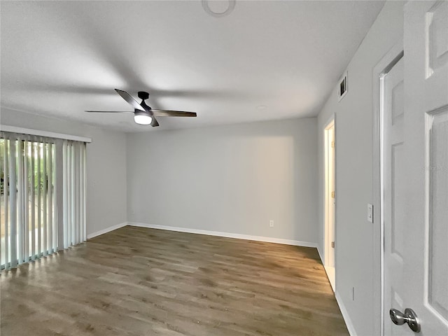 interior space with ceiling fan and dark hardwood / wood-style flooring