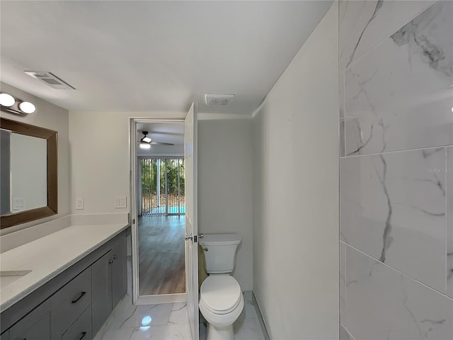 bathroom featuring toilet, vanity, ceiling fan, and tile flooring