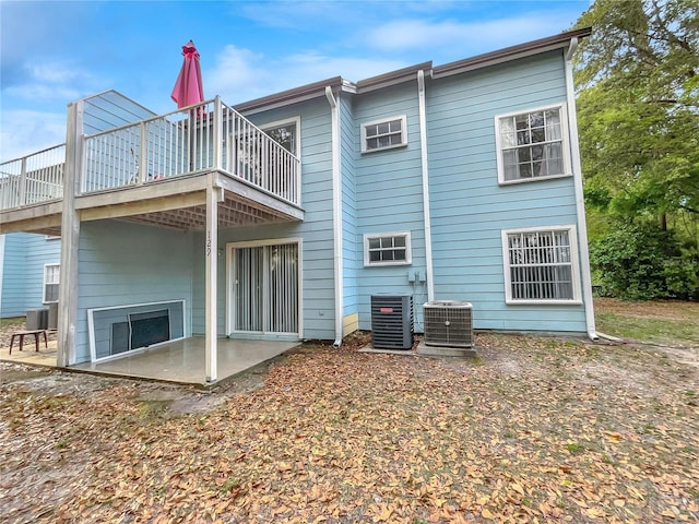 rear view of property featuring central air condition unit and a patio area