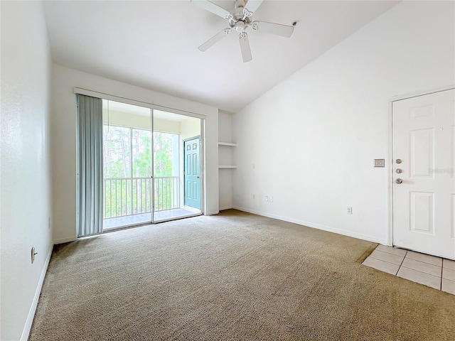 carpeted spare room with high vaulted ceiling and ceiling fan