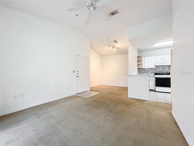 unfurnished living room with light carpet, ceiling fan, and vaulted ceiling