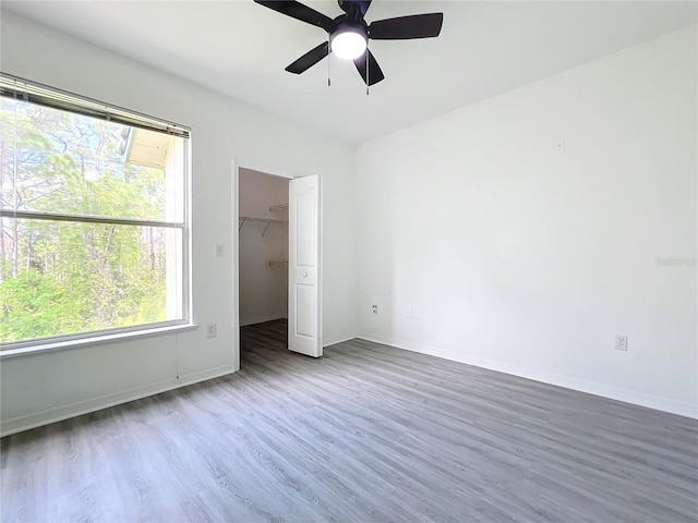 spare room featuring ceiling fan and dark hardwood / wood-style flooring