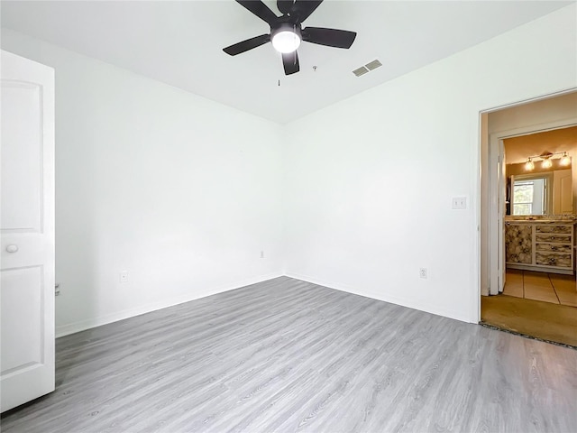 empty room with light hardwood / wood-style flooring and ceiling fan