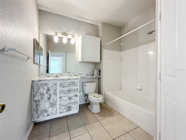 full bathroom featuring tiled shower / bath, toilet, tile flooring, and vanity