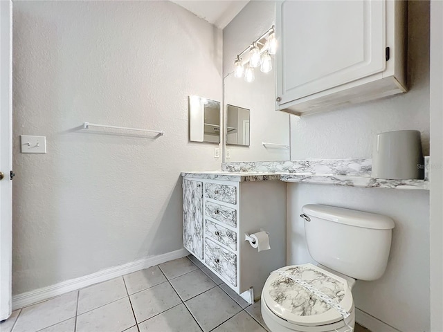 bathroom with vanity, tile floors, and toilet