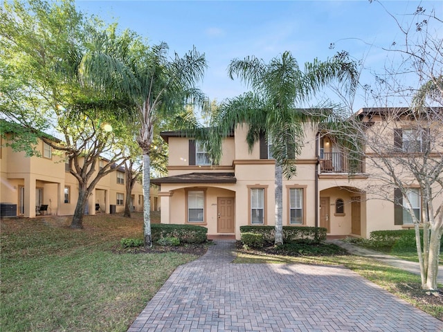 view of front of home with a balcony and central AC unit