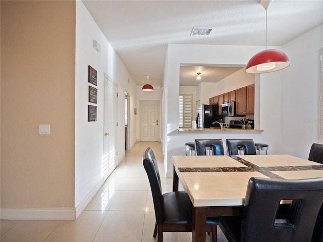 dining room featuring light tile patterned flooring