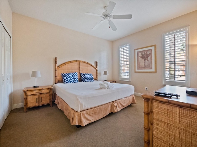 carpeted bedroom with a closet and ceiling fan