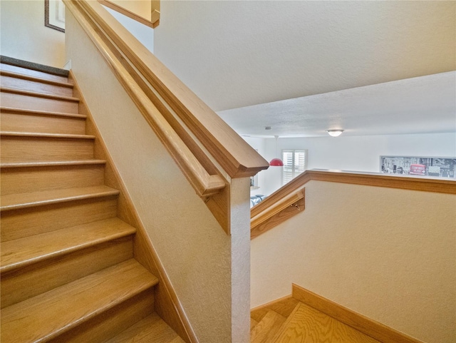 staircase featuring hardwood / wood-style flooring