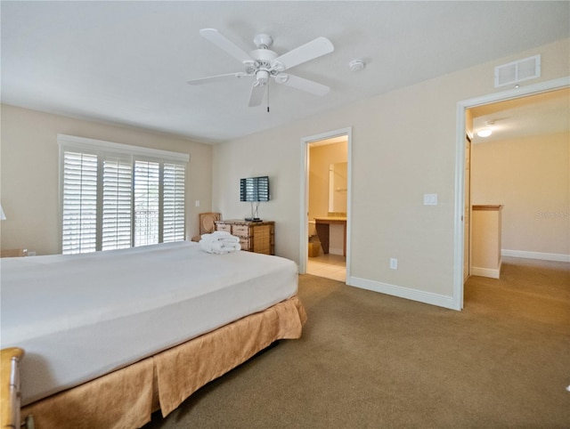 bedroom featuring ceiling fan, light carpet, and connected bathroom