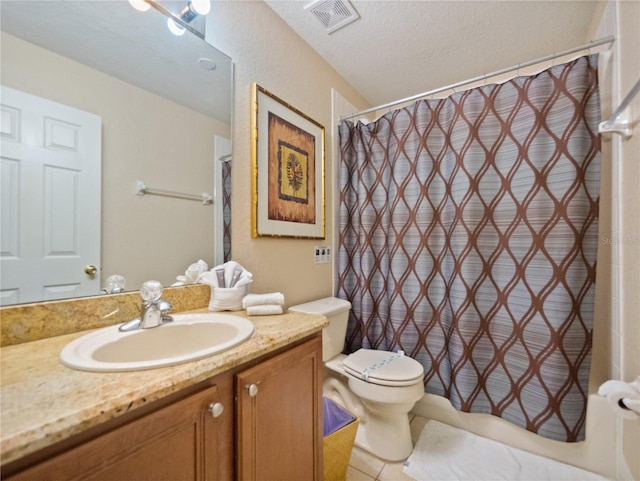 bathroom with vanity, tile patterned flooring, toilet, a textured ceiling, and curtained shower