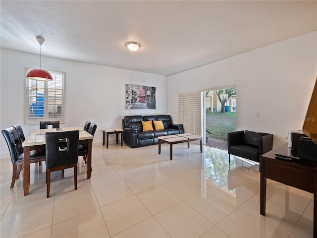 tiled dining area with a textured ceiling