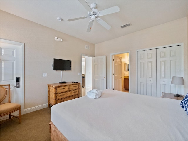 bedroom with ensuite bath, ceiling fan, a closet, and light colored carpet