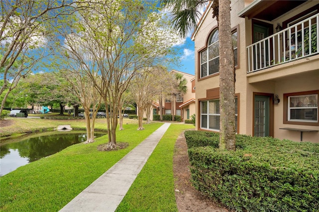 view of property's community with a lawn