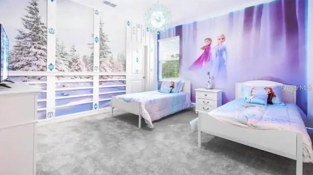 bedroom featuring a chandelier and carpet