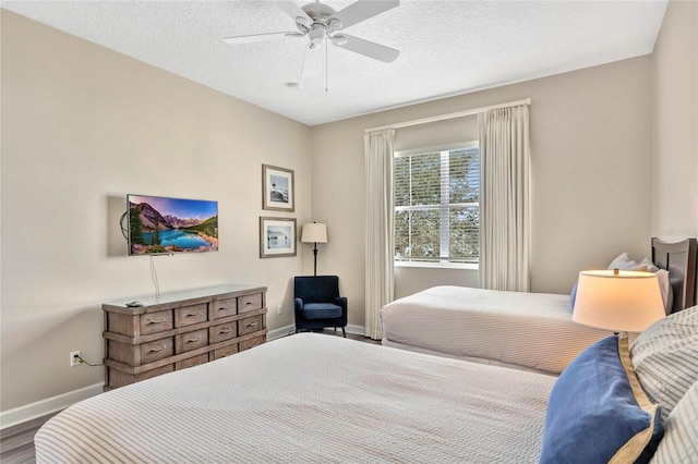 bedroom featuring ceiling fan, a textured ceiling, and hardwood / wood-style floors