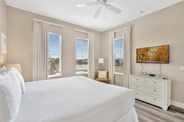 bedroom featuring light wood-type flooring and ceiling fan