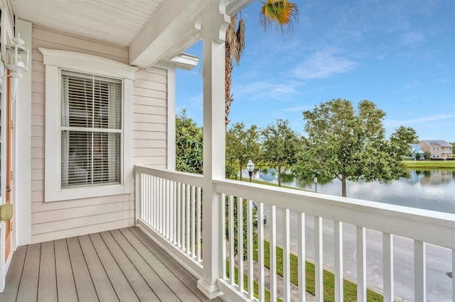 wooden terrace featuring a water view