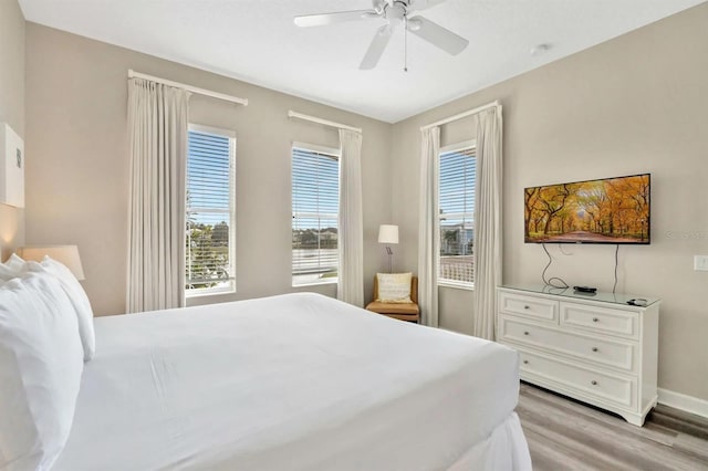 bedroom with light wood-type flooring and ceiling fan