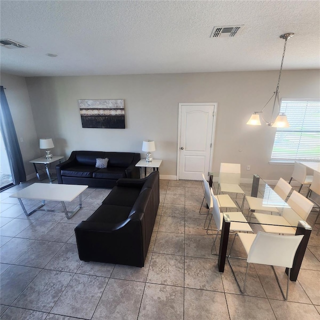 living room with tile flooring and a textured ceiling