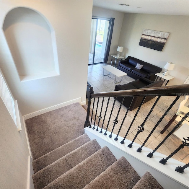 stairs with light tile floors