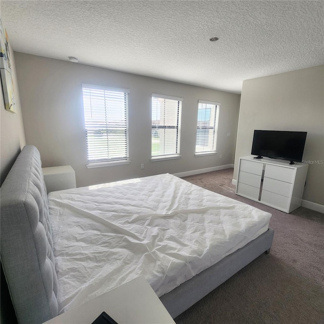 carpeted bedroom featuring a textured ceiling