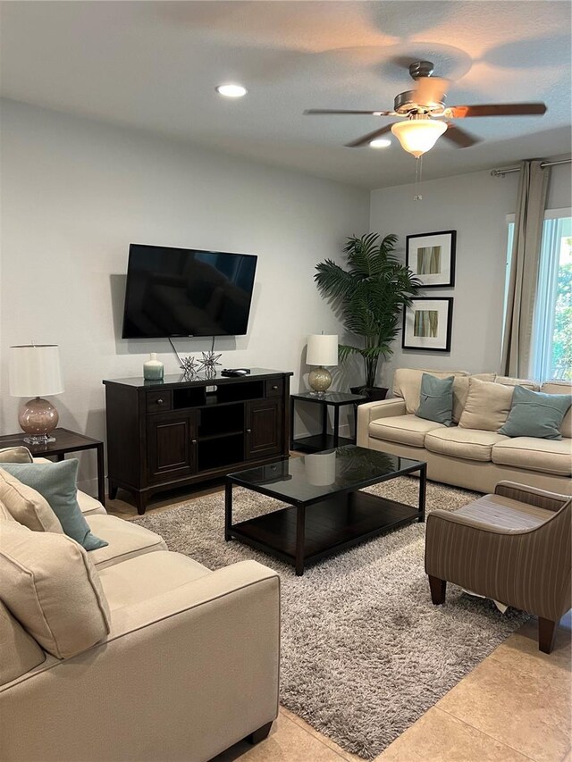 tiled living room featuring ceiling fan