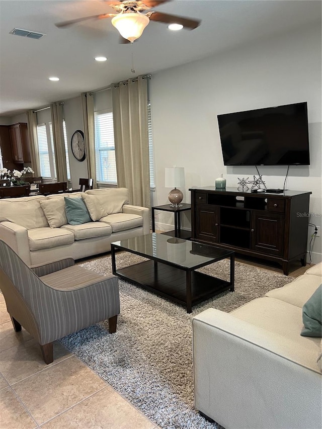 living room featuring light tile patterned floors, ceiling fan, visible vents, and recessed lighting