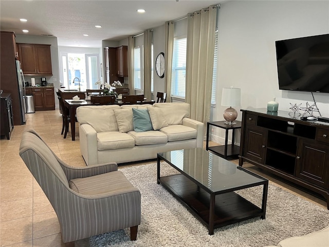 living room with recessed lighting and light tile patterned flooring