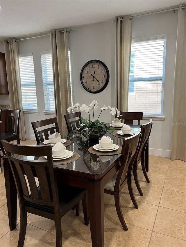 dining room featuring light tile patterned floors and baseboards