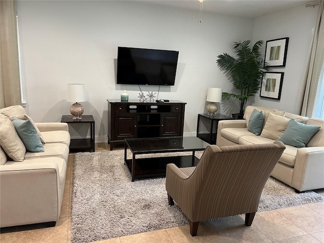 living room with baseboards and light tile patterned floors