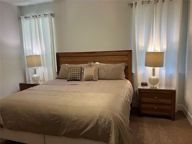 bedroom with dark colored carpet