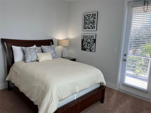 bedroom with carpet, access to outside, and baseboards